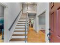 Bright foyer boasts hardwood floors, a staircase, and access to multiple rooms at 3915 Woolbridge Way, Marietta, GA 30062