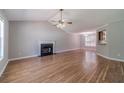 Bright living room with hardwood floors, fireplace, vaulted ceiling, and ample natural light at 647 New England Way, Lawrenceville, GA 30046