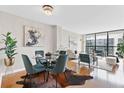 Open-concept dining area with modern lighting, stylish furniture, and hardwood floors at 1280 W Peachtree Nw St # 3208, Atlanta, GA 30309