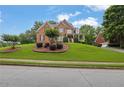 Traditional brick home with lush front yard and manicured landscaping on a sunny day at 793 Fairington Pl, Lawrenceville, GA 30044