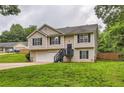 Charming two-story home featuring neutral siding, black shutters, a well-manicured lawn at 275 Mountain Way, Covington, GA 30016