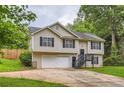 Charming two-story home featuring neutral siding, black shutters, and an attached two car garage at 275 Mountain Way, Covington, GA 30016