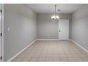 Open dining room featuring tile floors, a modern light fixture, and neutral wall paint at 7712 Autry Cir # 701, Douglasville, GA 30134