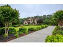 Beautiful home with lush landscaping, a long driveway, and a well-maintained lawn at 2675 Portabella Ln, Cumming, GA 30041