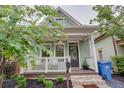 Inviting home with a lovely porch, framed by lush trees and manicured landscaping at 151 Savannah Se St, Atlanta, GA 30316