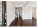 Bright entryway featuring hardwood floors, white trim, and a view into the home at 4090 Danbury Farms Dr, Cumming, GA 30040