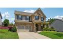 Beautiful two-story brick home with a well-maintained front lawn and an attached two-car garage at 4090 Danbury Farms Dr, Cumming, GA 30040