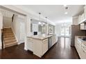 Open-concept kitchen with stainless steel appliances, granite countertops, and a large island at 4090 Danbury Farms Dr, Cumming, GA 30040