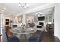 Open concept kitchen and living room featuring stainless steel appliances and breakfast nook at 4090 Danbury Farms Dr, Cumming, GA 30040