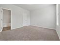 Spacious, carpeted bedroom with a window and ample natural light, ready for personalization at 2182 Talmai Dr, Snellville, GA 30078