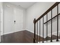 Inviting entryway with dark hardwood floors and staircase, leading to the home's interior at 2182 Talmai Dr, Snellville, GA 30078