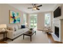Bright living room with fireplace, white couch, ceiling fan, and art at 3641 Ridge Towne Dr, Duluth, GA 30096