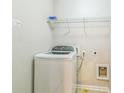 Convenient laundry room includes a washing machine and shelving at 4358 Grove Field Ct, Suwanee, GA 30024