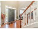 Bright foyer featuring hardwood floors, a staircase, and a view into the living area at 1031 High Tide Ct, Loganville, GA 30052