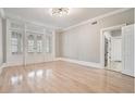 Bright living room featuring hardwood floors, neutral paint, and beautiful french doors at 1156 Piedmont Ne Ave # B3, Atlanta, GA 30309