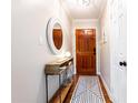 Inviting foyer featuring hardwood floors and a stylish mirror hung above a wooden console table at 1295 Lindenwood Ne Ln, Brookhaven, GA 30319