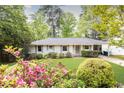 Charming one-story home with a well-manicured lawn, fresh landscaping and a painted brick exterior at 1295 Lindenwood Ne Ln, Brookhaven, GA 30319