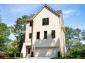 Beautifully designed home with brick and siding, complemented by black-framed windows and lush green surroundings at 2745 S Bamby Ne Ln, Brookhaven, GA 30319