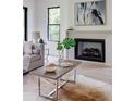 Living room showcases a contemporary fireplace, hardwood floors, and bright natural light at 2745 S Bamby Ne Ln, Brookhaven, GA 30319
