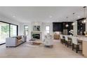 Open concept living area with a fireplace, modern kitchen, and stylish furnishings at 2745 S Bamby Ne Ln, Brookhaven, GA 30319