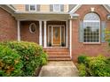 Inviting front porch with brick steps and columns, leading to an elegant front door at 223 Oak Grove Dr, Dallas, GA 30157