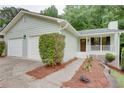 A well maintained single-story home with a two-car garage and landscaped front yard at 3960 Rocmar Dr, Snellville, GA 30039