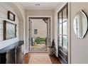Bright foyer with hardwood floors, elegant decor, and a view of the outdoor patio through glass doors at 4224 Dogwood Bend Park, Berkeley Lake, GA 30096