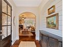 Inviting foyer with hardwood floors, and view into a living room with archway leading to dining area at 4224 Dogwood Bend Park, Duluth, GA 30096