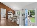 Bright dining area with hardwood floors, natural light, a modern chandelier, and backyard views at 657 Polk Nw St, Marietta, GA 30064