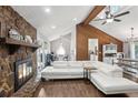 Inviting living room features a stone fireplace, vaulted ceiling, wood accents, and modern white furniture at 657 Polk Nw St, Marietta, GA 30064