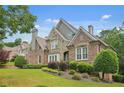 Charming two-story home with brick and stone exterior and well-maintained lawn at 702 Crescent Cir, Canton, GA 30115