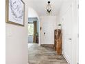 Bright entryway with wood-look flooring, decorative light fixture, and an arched doorway leading to other rooms at 1417 Woodrow Kay Rd, Rockmart, GA 30153