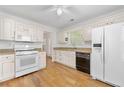 Bright kitchen featuring white cabinets, modern appliances, and hardwood floors at 3040 Majestic Park Ct, Duluth, GA 30096