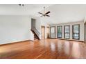 Bright living room with hardwood floors, high ceilings, a ceiling fan and large windows offering great natural light at 3966 N Indian Nw Cir, Kennesaw, GA 30144