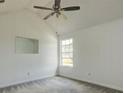 Bright bedroom featuring neutral walls, carpet, a ceiling fan, and a window at 6684 Crane Ave, Fairburn, GA 30213
