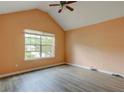 Bright bedroom featuring warm walls, laminate flooring, a ceiling fan, and a window at 6684 Crane Ave, Fairburn, GA 30213
