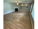 Spacious living room featuring a fireplace and modern flooring at 6684 Crane Ave, Fairburn, GA 30213