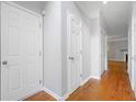 Bright hallway featuring hardwood floors and white doors, leading to various rooms at 5057 Lower Elm St, Atlanta, GA 30349