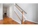 Elegant staircase with wooden handrail and gray carpet runners connecting the floors at 5057 Lower Elm St, Atlanta, GA 30349