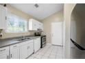 Well-lit kitchen features white cabinets and stainless steel appliances at 5422 Timor Trl, Lithonia, GA 30038