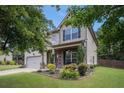 Charming two-story home features a manicured front lawn, attached garage, and inviting curb appeal at 5925 Whitney Ct, Cumming, GA 30041