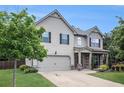 Charming two-story home features a manicured front lawn, attached garage, and inviting curb appeal at 5925 Whitney Ct, Cumming, GA 30041