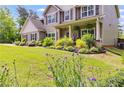 Beautifully landscaped front yard featuring colorful plants and green grass, showcasing the home's curb appeal at 13 Westbrook Rd, Carrollton, GA 30116