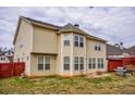 Spacious backyard with a well-maintained lawn, wood fence, grill, patio, and ample natural light at 963 Ensign Peak Ct, Lawrenceville, GA 30044