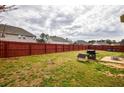Expansive backyard featuring a full wood fence, lush grass, and patio, perfect for outdoor enjoyment at 963 Ensign Peak Ct, Lawrenceville, GA 30044