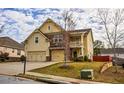 Two-story home with a two-car garage, front lawn and a combination of stone and siding at 963 Ensign Peak Ct, Lawrenceville, GA 30044