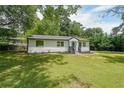 Front yard of a single-story home with a well-manicured lawn and black mulch at 2621 Gordon Se Cir, Smyrna, GA 30080