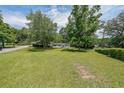 Expansive front yard view of a single-story home with mature trees and a lush lawn at 2621 Gordon Se Cir, Smyrna, GA 30080