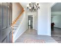 Inviting foyer featuring beautiful hardwood flooring and staircase that leads to the upper level at 630 Beckenham Walk Dr, Dacula, GA 30019