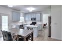 Updated kitchen with modern cabinets, stainless steel appliances, island, and adjacent dining area at 630 Beckenham Walk Dr, Dacula, GA 30019